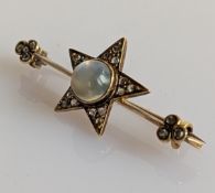 A moonstone and diamond star brooch, the central round cabochon-cut moonstone measuring