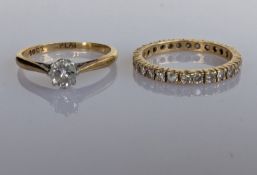 A solitaire diamond ring on a yellow gold and platinum claw setting, the diamond approximately 0.25 