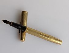 A mid-century Waterman's gold-cased fountain pen with reeded decoration, hallmarked 9ct for S J Rose
