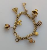 A yellow gold charm bracelet, all hallmarked 9ct, 16.2g