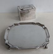A George V square silver salver with pie-crust border, raised on four claw and ball feet, hallmarked