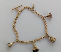 A gold flat curb-link Albert watch chain with T-bar and lobster clasp, hallmarked 15ct to each