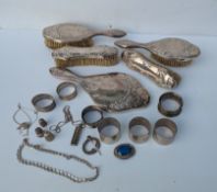 A George V silver five-piece brush set with Art Nouveau-style embossed decoration, hallmarked