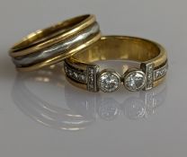 A diamond, gold and platinum band, the twin central diamond in a collet setting