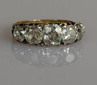 A Victorian five-stone diamond ring in a yellow gold setting, set with five old mine-cut diamonds