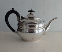 A George V silver teapot with ebonised knop and handle, hallmarked for London 1920, makers mark rubb