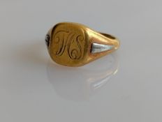 A yellow gold signet ring with platinum decoration to shoulders, initialled and inscribed to inside