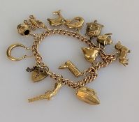 A yellow gold charm bracelet, all hallmarked 9ct, 22g