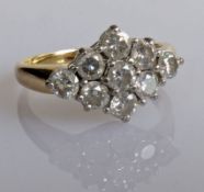 A nine-stone diamond navette ring on a yellow gold tapering shank, total round-cut diamond weight