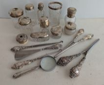 A selection of late Victorian and later rococo-style silver-topped vanity bottles and a variety of s