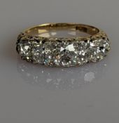 A Victorian five-stone diamond ring on a yellow gold setting, set with five old-cut diamonds
