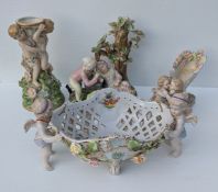 Three 19th century figurines with blue crossed swords, basket 34 cm W (one wing detached), group fig