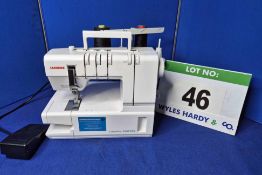 A JANOME Cover Pro 2000CPX Hemming Sewing Machine with Four Threads Option and Treadle Operation