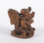 Netsuke, Buchsbaum, Kinko Sennin auf einem Karpfen über Wellen, sign., Japan, 19.Jh.