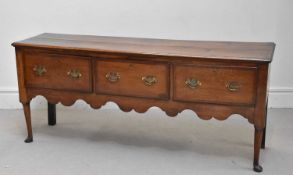 An 18th century oak dresser base, height 81cm, width 187cm, depth 50cm.