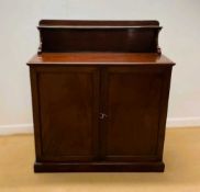 STRAHAN & CO, DUBLIN; a mahogany linen cupboard, having galleried back above twin doors which