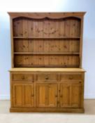 A large pine farmhouse dresser, with three drawers and three cupboards below, height 199cm, width