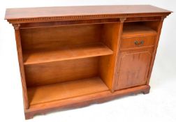 A Regency-style yew wood floor standing bookcase with open shelves to the left, all flanked by