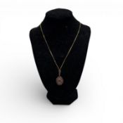 Gold necklace with garnet pendant