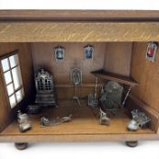 Wooden viewing cabinet with silver miniatures