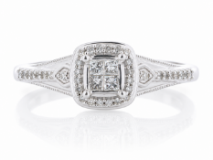 Four princess cut diamonds create a centre cluster, and is surrounded by a halo of twenty single cut
