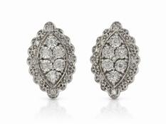 Six single cut diamonds are set in a marquise shaped cluster with a halo of eight single diamonds on