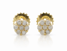 A round cluster of seven round brilliant cut diamonds are set in each of these classic diamonds stud