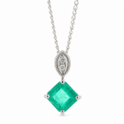 A charming pendant with one emerald cut emerald sitting on a sideways setting with diamond set bale.