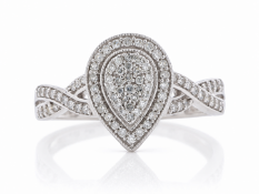 Twenty seven single cut diamonds create a centre pear shaped cluster, which is surrounded by a