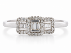 Two baguette cut diamonds are surrounded by a square halo of round diamonds to create the centre