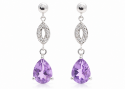 A stunning pair of dangle earrings. Each earring is a 9ct white gold stud ball that sits above two