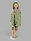Puppe um 1900, farbiges Gesicht und Haare mit Brustblatt aus Porzellan, Porzellanarme, Lederfüße an