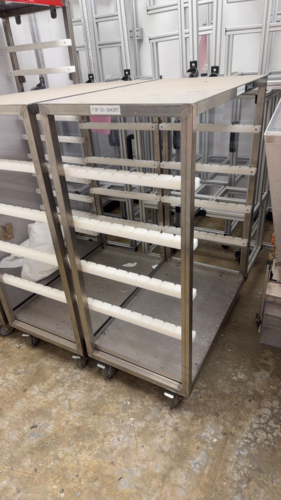 Stainless Steel Ridged Rack Pair of stainless steel rolling racks with plastic rail supports ...