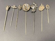 SEVEN VARIOUS SILVER AND BASE METAL STICK PINS