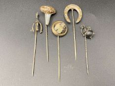 FIVE VARIOUS SILVER AND BASE METAL STICK PINS