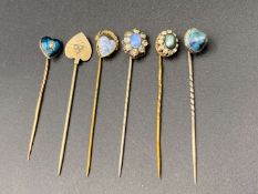 SIX VARIOUS GOLD, GILT AND BASE METAL STICK PINS