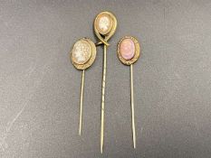 THREE VARIOUS BASE METAL CAMEO STICK PINS