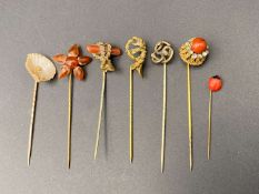 SEVEN VARIOUS GILT AND BASE METAL STICK PINS