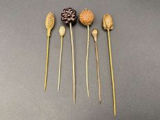 SIX VARIOUS GILT AND BASE METAL STICK PINS
