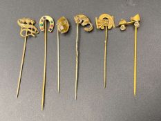 SIX VARIOUS GILT METAL AND PASTE SET STICK PINS