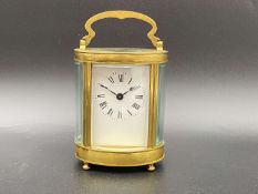 EARLY 20th CENTURY FRENCH LACQUERED BRASS OVAL CARRIAGE TIMEPIECE,
