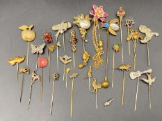 TWENTY EIGHT VARIOUS BASE METAL, GLASS AND ENAMELED STICK PINS
