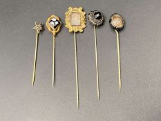FIVE VARIOUS GILT AND BASE METAL MEMORIAL STICK PINS&nbsp;