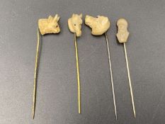 FOUR VARIOUS LATE 19TH CENTURY CARVED BONE STICK PINS&nbsp;