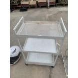 A THREE TIER FOUR WHEELED TROLLEY