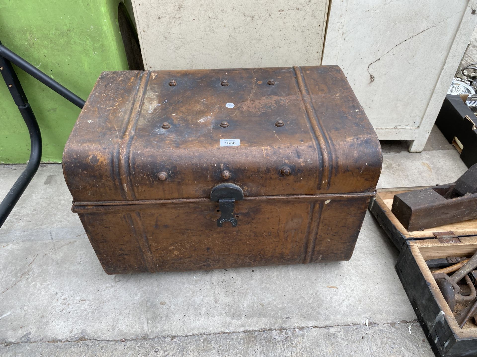 A VINTAGE METAL TRAVEL TRUNK