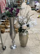 A LARGE METAL TRUMPET VASE AND A FURTHER CERAMIC VASE BOTH CONTAINING ARTIFICIAL FLOWERS