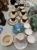 A VINTAGE POOLE POTTERY TREACLE GLAZED TEA SET TOGETHER WITH FURTHER CUPS AND SAUCERS BY COLCLOUGH