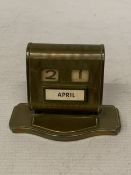 A 1930'S BRASS PERPETUAL DESK CALENDAR