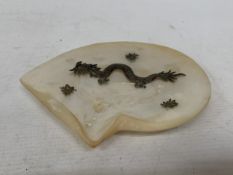 A CHINESE EXPORT SILVER DRAGON RELIEF DISH, MOUNTED ON A MOTHER OF PEARL SHELL, 18CM X 14CM